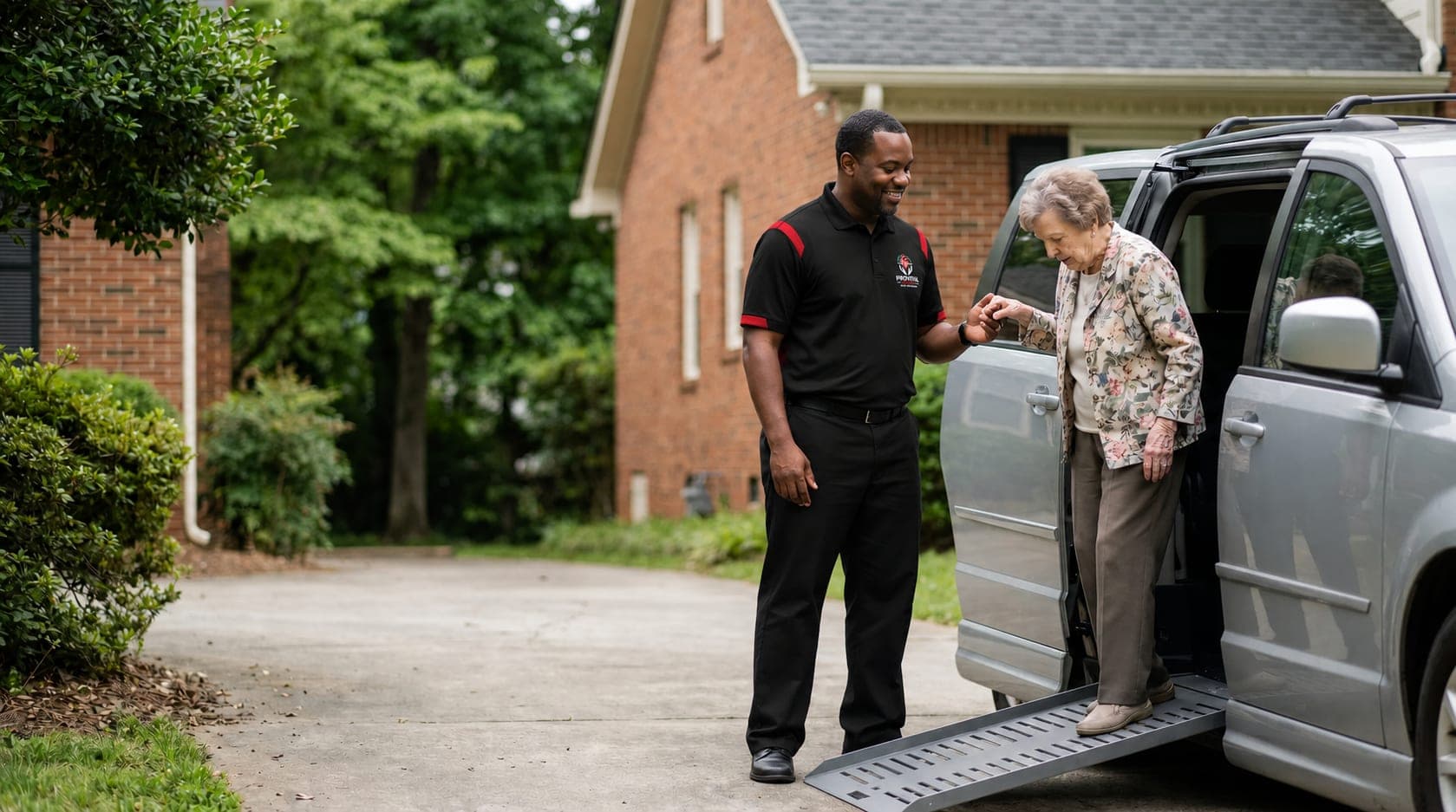 A ProVital Transit driver helping a client out of a wheelchair-accessible van